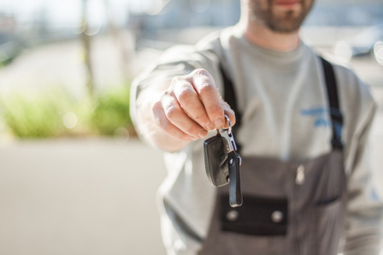 Man holding car keys.