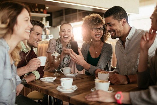 Group of millennials having coffee in a café.